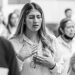 A woman in prayer with closed eyes at a gathering in Ciudad de México.
