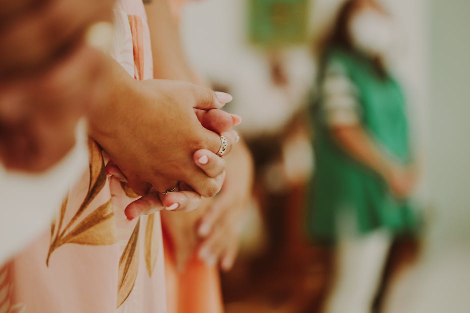 Close-up of clasped hands in a prayerful pose, symbolizing spirituality and reflection.