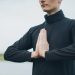 Close-up of a person meditating outdoors with hands in prayer position, promoting wellness.