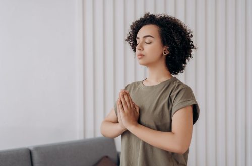 Young woman meditating indoors, practicing mindfulness and relaxation. Peaceful and serene atmosphere.