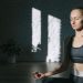 A woman meditates indoors in a serene yoga session, embracing mindfulness and tranquility.