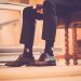 Elegant shoes and socks in a serene church setting capture a moment of reflection.
