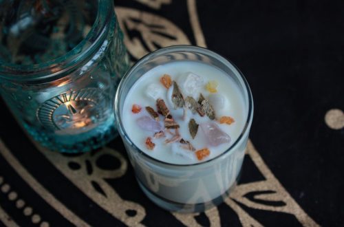 Top-down view of an aromatic candle with crystals in a decorative setting. Ideal for relaxation themes.