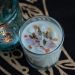 Top-down view of an aromatic candle with crystals in a decorative setting. Ideal for relaxation themes.