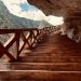 Scenic view of wooden stairs leading through a mountain passage in Bhatwari, showcasing nature's beauty.