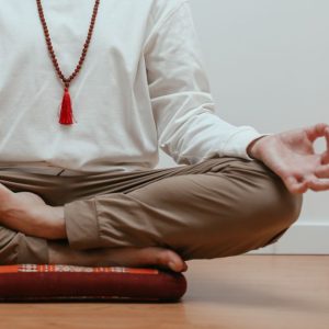 Close-up of a person meditating in a serene indoor setting, focusing on mindfulness.