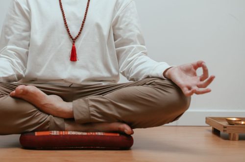 Close-up of a person meditating in a serene indoor setting, focusing on mindfulness.