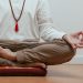 Close-up of a person meditating in a serene indoor setting, focusing on mindfulness.