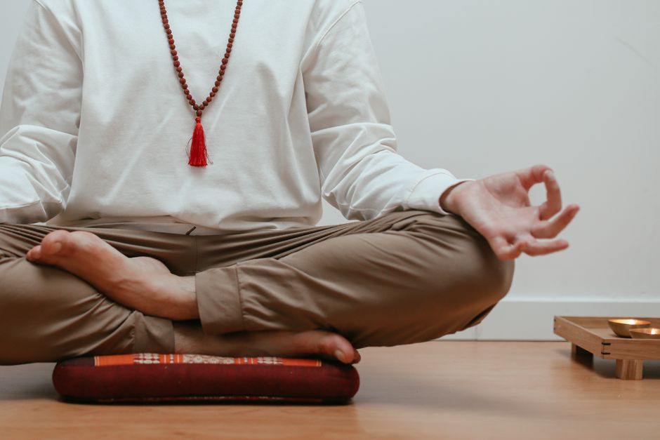 Close-up of a person meditating in a serene indoor setting, focusing on mindfulness.