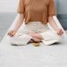 A person meditating outdoors with a singing bowl, embracing serenity and mindfulness.