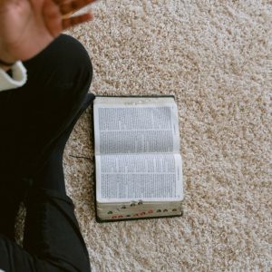 Open Bible on a soft carpet captures a serene moment for reflection and study.