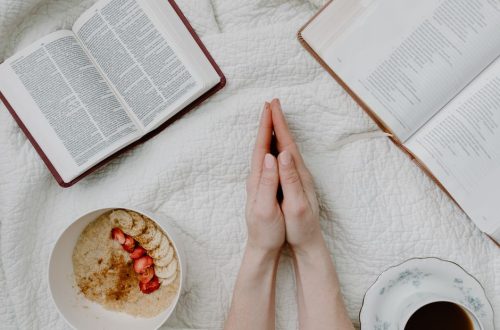 A serene morning scene with a person praying, an open Bible, oatmeal, and coffee.