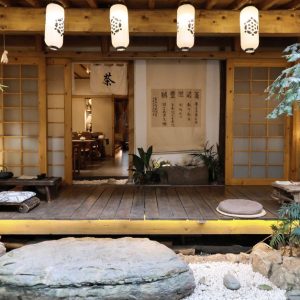 Serene Japanese tea room with lanterns and traditional decor, ideal for meditation and cultural appreciation.